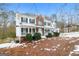 Two-story house with brick and white siding, porch, and landscaping in winter at 380 River Point Dr, Mcdonough, GA 30252