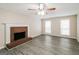 Living room with fireplace, hardwood floors, and ceiling fan at 380 River Point Dr, Mcdonough, GA 30252