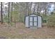 White storage shed with gray trim at 1102 Hip Pocket Rd, Peachtree City, GA 30269