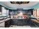 Well-equipped kitchen with dark wood cabinets and tiled backsplash at 238 First St, Bowdon, GA 30108