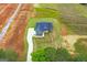 Aerial view of the home featuring a long driveway, green siding and dark roof at 123 Oak Road, Locust Grove, GA 30248
