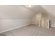 Spacious carpeted bonus room with sloped ceilings and stairs to additional rooms at 123 Oak Road, Locust Grove, GA 30248
