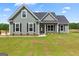 Charming single-Gathering home with green siding and a well-manicured lawn at 123 Oak Road, Locust Grove, GA 30248