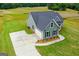 Desirable single-Gathering home with green siding and a concrete driveway and attached garage at 123 Oak Road, Locust Grove, GA 30248