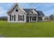 Charming gray two-story home with well-maintained lawn and traditional design elements at 123 Oak Road, Locust Grove, GA 30248