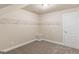 Neutral carpeted walk in closet featuring a door and shelving on the left side at 123 Oak Road, Locust Grove, GA 30248