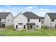 Home's backyard with healthy green grass, a covered patio and views of neighboring homes at 13232 Tolstoy Drive, Covington, GA 30014