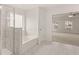 Bathroom with a shower, tub, and a view into the main bedroom at 13232 Tolstoy Drive, Covington, GA 30014
