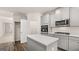 Modern kitchen features gray cabinets, stainless steel appliances, and a large island at 13232 Tolstoy Drive, Covington, GA 30014