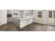 Modern kitchen with gray cabinets, white countertops, and dark hardwood floors at 13232 Tolstoy Drive, Covington, GA 30014