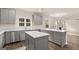 Modern kitchen with gray cabinets, stainless steel appliances, and a large center island at 13232 Tolstoy Drive, Covington, GA 30014