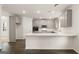 Modern kitchen with gray cabinets, white countertops, and dark hardwood floors at 13232 Tolstoy Drive, Covington, GA 30014