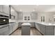 Modern kitchen with gray cabinets, white countertops, and island at 13232 Tolstoy Drive, Covington, GA 30014