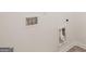 Laundry room with built-in cabinets and tile floor at 13232 Tolstoy Drive, Covington, GA 30014