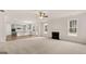Open living room with kitchen view, fireplace, and hardwood floors at 13232 Tolstoy Drive, Covington, GA 30014