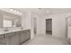 Main bathroom boasts double vanity, walk-in shower, and bathtub at 13232 Tolstoy Drive, Covington, GA 30014