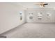 Spacious main bedroom with carpeted floors and three windows at 13232 Tolstoy Drive, Covington, GA 30014