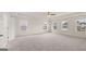 Main bedroom with carpet, windows, and multiple doors at 13232 Tolstoy Drive, Covington, GA 30014