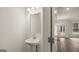 Clean powder room with pedestal sink and mirror at 13232 Tolstoy Drive, Covington, GA 30014