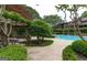Beautifully landscaped pool area featuring shade trees and ample seating at 507 Embers Se Dr, Marietta, GA 30067