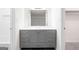 Bathroom vanity featuring gray cabinets and a contrasting white countertop and a large mirror at 507 Embers Se Dr, Marietta, GA 30067