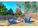 Inviting backyard with a stone firepit and Adirondack chairs, perfect for outdoor entertaining at 37 Highcrest Dr, Acworth, GA 30101
