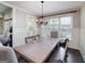 Bright dining room with wainscoting, hardwood floors, a large table, and an elegant chandelier at 37 Highcrest Dr, Acworth, GA 30101
