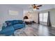 Living room featuring hardwood floors, a blue couch, and natural light from the windows at 37 Highcrest Dr, Acworth, GA 30101