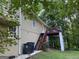 Back exterior view of home with wooden deck, stairs, and wooded backyard at 3746 Chapel Hill Road, Douglasville, GA 30135