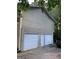 A house featuring a three-car garage, an entrance door and a car parked in the driveway at 3746 Chapel Hill Road, Douglasville, GA 30135