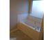Relaxing bathroom featuring garden tub and tile flooring at 3590 Stephens Creek Pl, Loganville, GA 30052