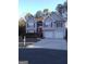 Two-story house with attached double garage and red accents at 3590 Stephens Creek Pl, Loganville, GA 30052