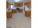 Kitchen with wood cabinets, stainless steel appliances, and light flooring at 3590 Stephens Creek Pl, Loganville, GA 30052