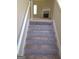 Staircase with neutral carpet leading to upper level at 3590 Stephens Creek Pl, Loganville, GA 30052