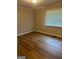 Bright bedroom with wood floors, a window with blinds, and neutral wall paint at 752 Jefferson Sw Ave, Atlanta, GA 30315