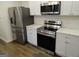 Modern kitchen with stainless steel appliances and white cabinets at 553 Highway 279, Fayetteville, GA 30214