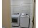 Laundry room with washer, dryer, and shelving unit at 553 Highway 279, Fayetteville, GA 30214