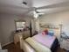 Bedroom featuring hardwood floors, ceiling fan, and a decorative dresser with a matching mirror at 220 Canterbury Ln, Lawrenceville, GA 30046