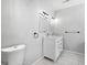 Updated bathroom with double vanity, modern lighting, and white tile flooring at 215 Elliott Rd, Mcdonough, GA 30252