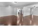 Open concept living area with hardwood floors and view into kitchen at 215 Elliott Rd, Mcdonough, GA 30252