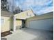 Inviting exterior featuring a two-car garage and charming front porch at 144 Cottsford Sw Dr # 22, South Fulton, GA 30331