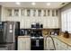 Modern kitchen with glass-front cabinets and granite countertops at 144 Cottsford Sw Dr # 22, South Fulton, GA 30331