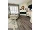 Cozy living room featuring hardwood floors, a fireplace, and lots of natural light at 144 Cottsford Sw Dr # 22, South Fulton, GA 30331