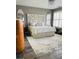 Spacious primary bedroom featuring a carved headboard, a chandelier, and a plush rug at 144 Cottsford Sw Dr # 22, South Fulton, GA 30331