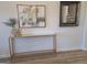 Close up of table decor in foyer with framed art and mirror at 376 Collier Mills Road, Lawrenceville, GA 30045