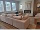 Comfortable living room featuring a sectional sofa, fireplace, and lots of natural light at 376 Collier Mills Road, Lawrenceville, GA 30045