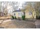 Ranch style home with yellow siding and a small yard at 1826 E Farris Ave, East Point, GA 30344