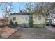 Yellow siding ranch home with a yard and driveway at 1826 E Farris Ave, East Point, GA 30344