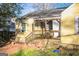Yellow house with wooden porch and steps at 1826 E Farris Ave, East Point, GA 30344