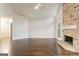 Spacious living room featuring a stone fireplace and hardwood floors at 208 Tennis Court Nw Ln, Kennesaw, GA 30144